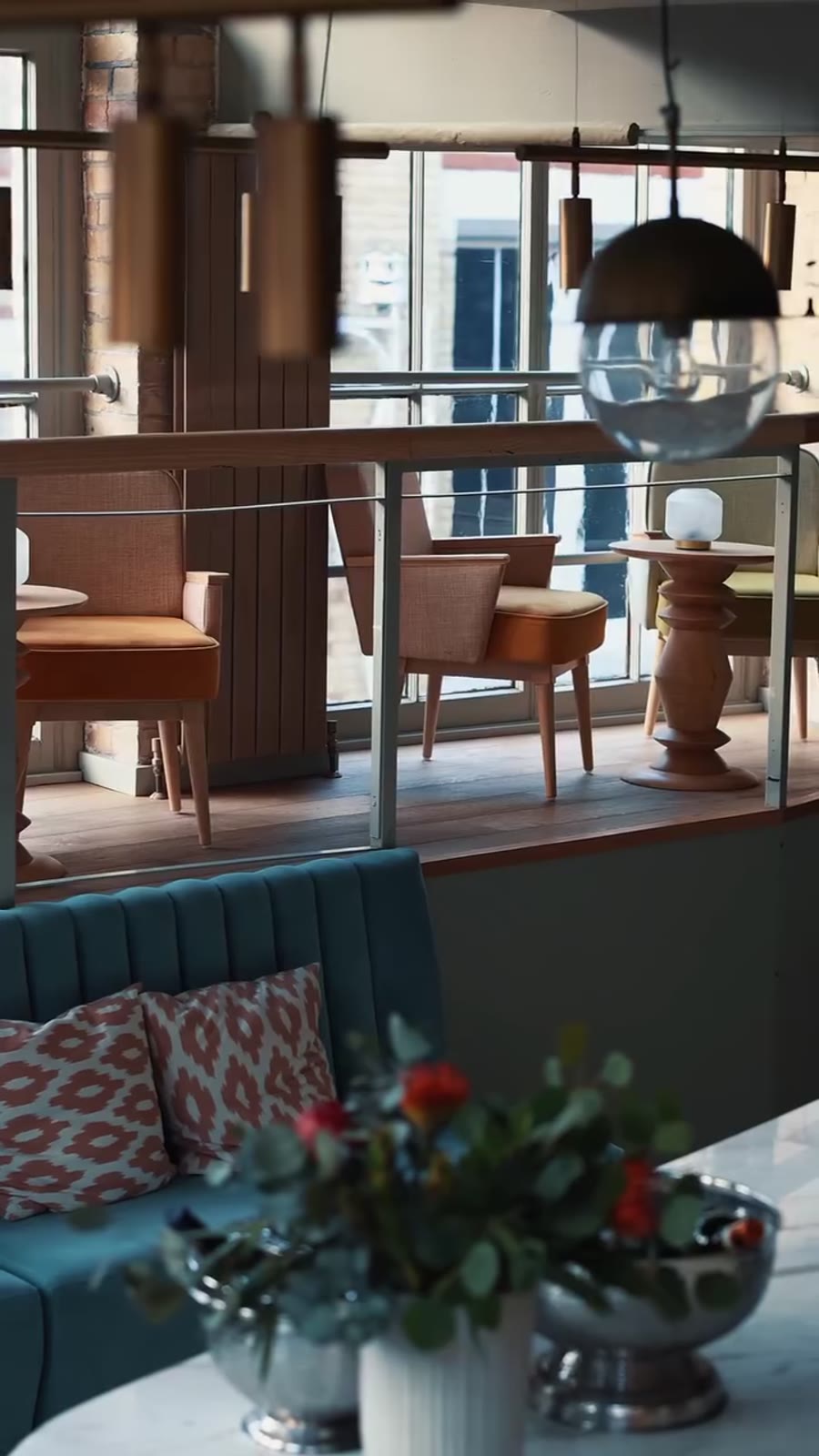 Blue velvet banquettes and marble tables